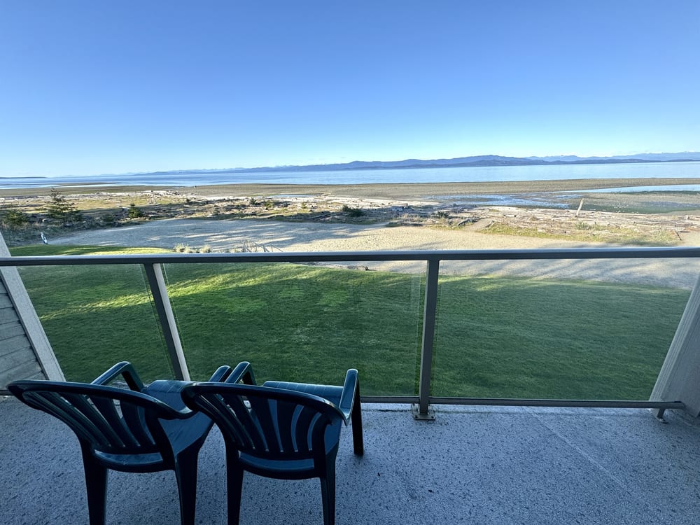 The private balcony with seating, looking west over the beach and the Strait of Georgia.